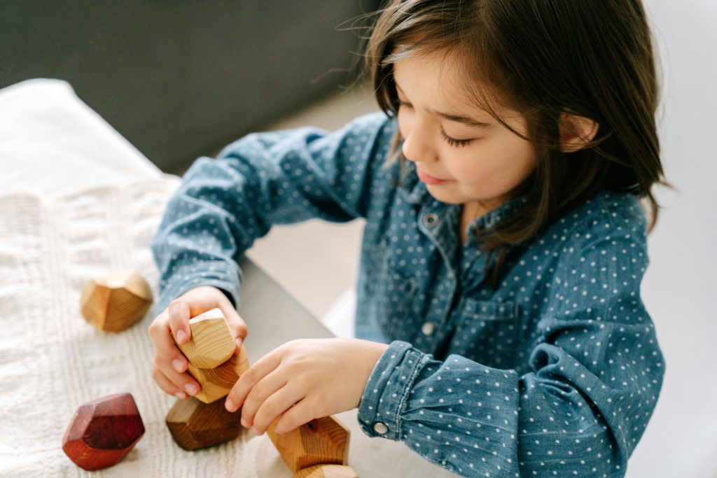 pexels-photo-8504531-8504531 A Girl Playing Wooden Blocks